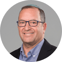 Professional middle-aged man smiling for a portrait, showcasing his expertise area.